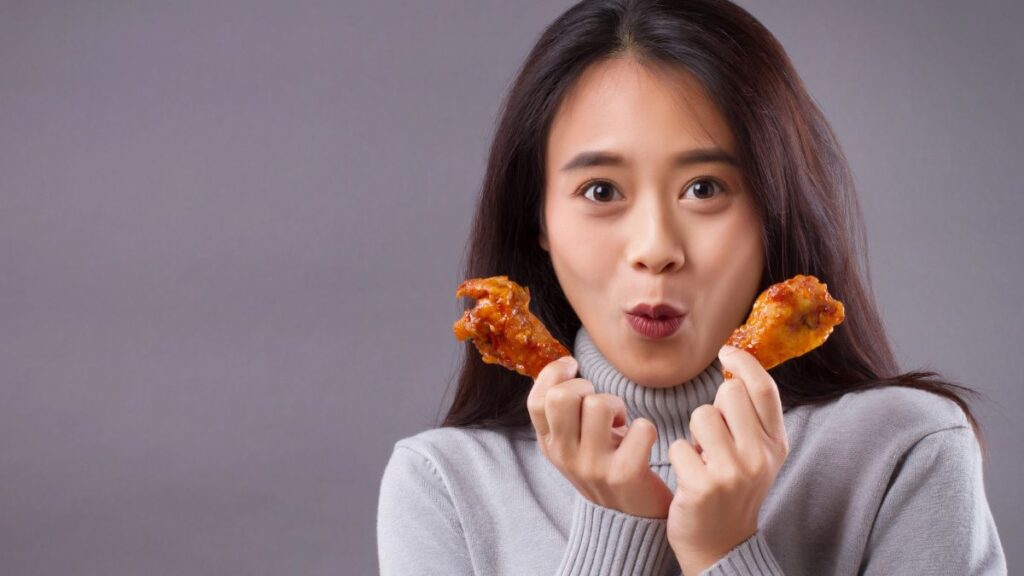 woman looking excited with fried wings