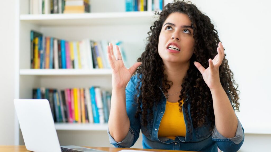 frustrated woman at computer looking up