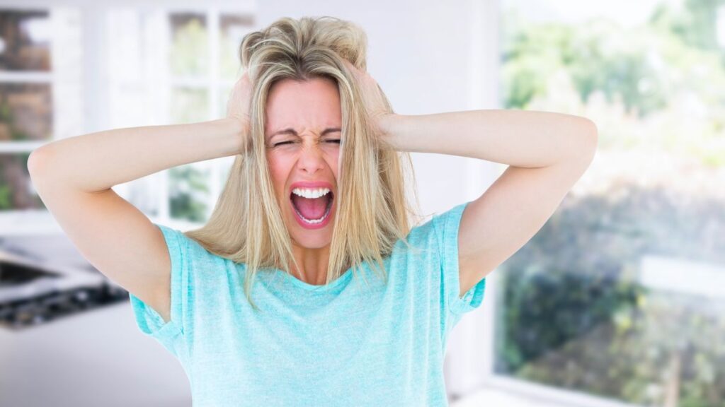 woman looking frustrated with hands in hair