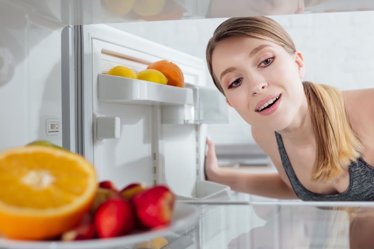 woman looking into her fridge