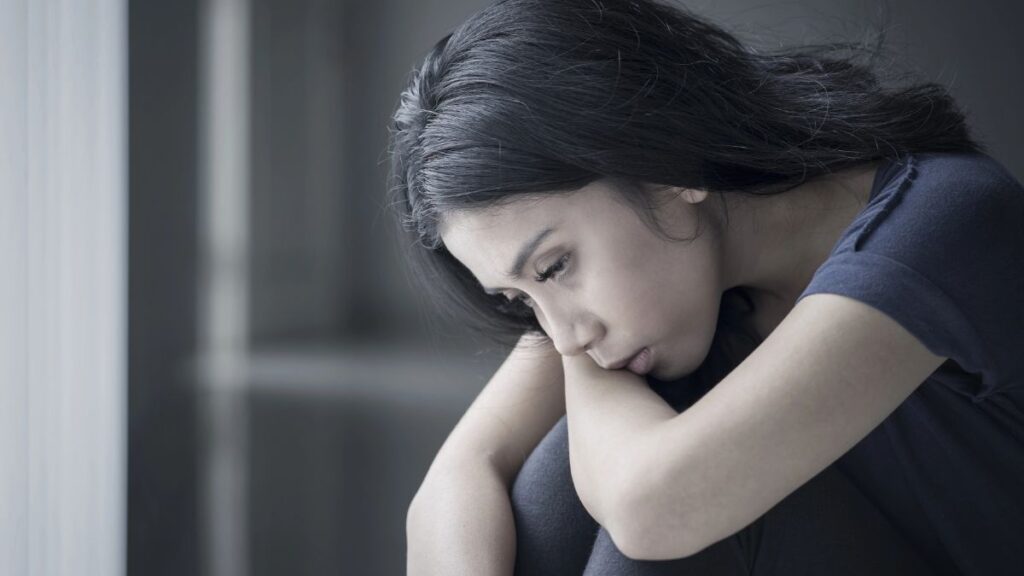 woman sitting looking depressed