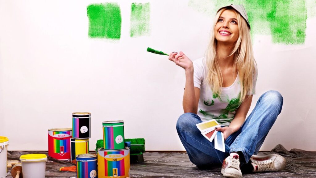 woman sitting with paint smiling