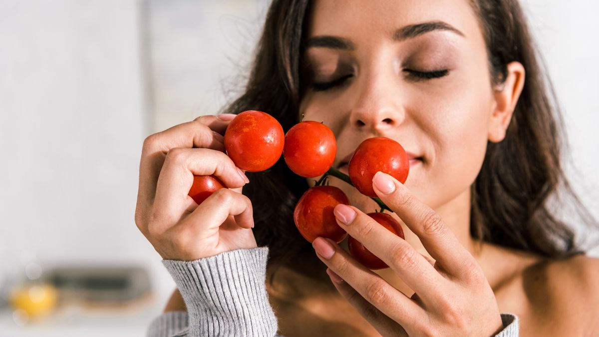 woman smelling cherry tomatoes