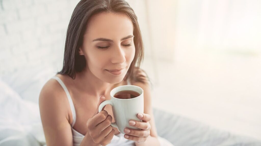 woman smelling cup of tea