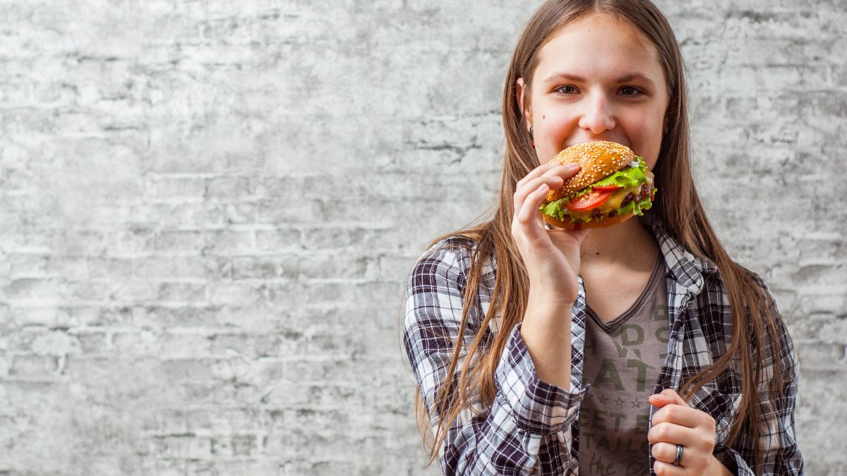 woman smiling with burger