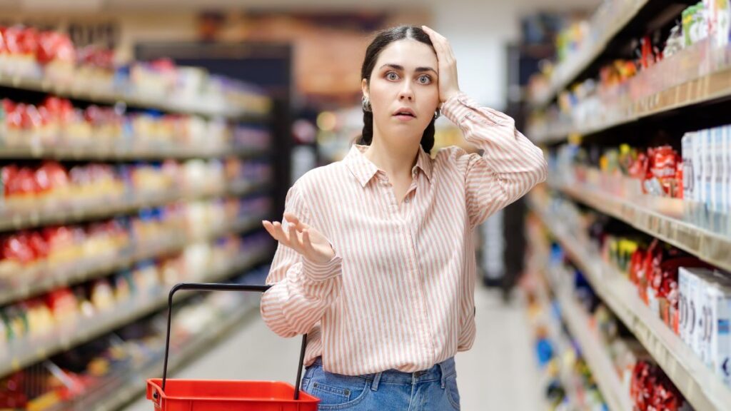 woman upset in grocery store hand on head