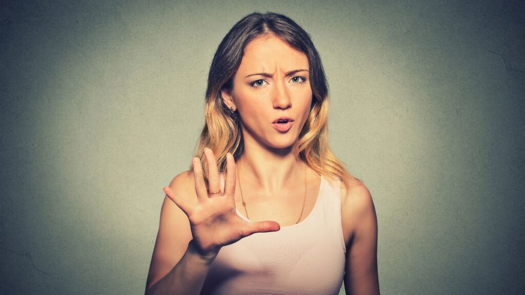 woman with hand up showing stop