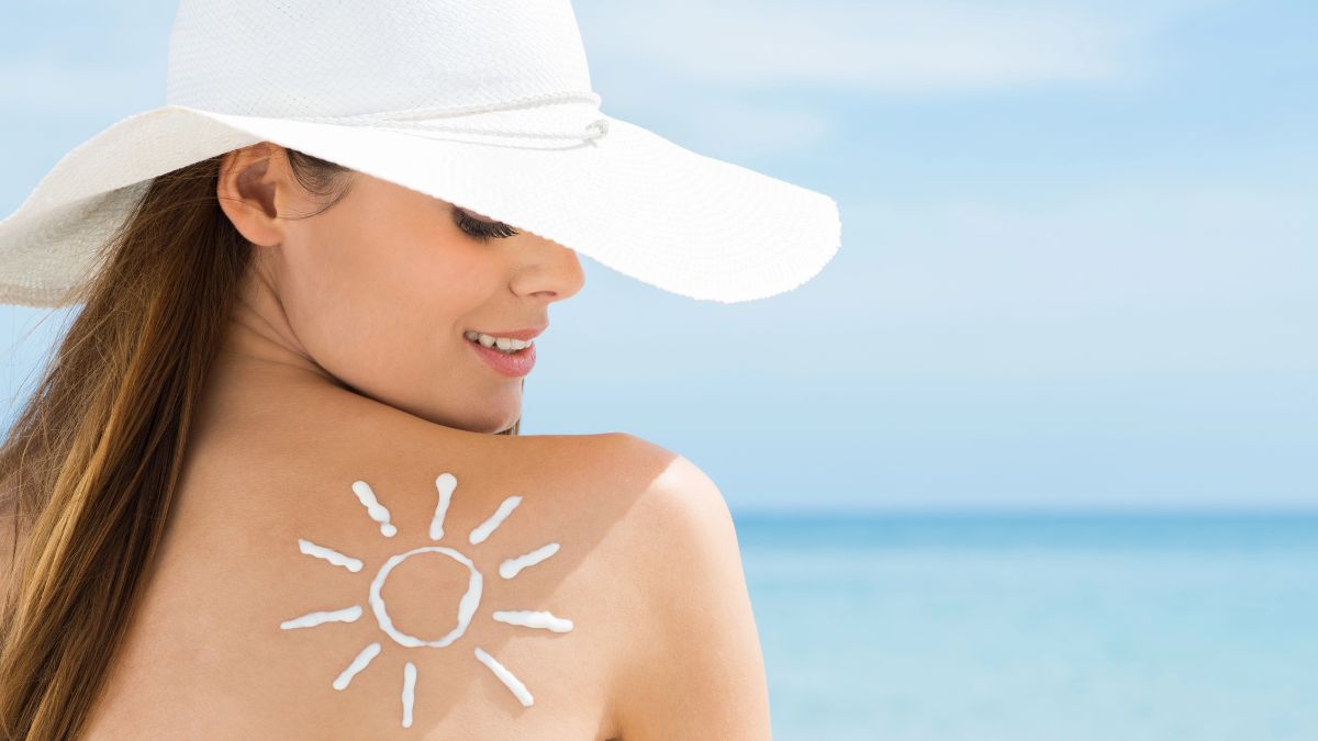 woman with sun in sunscreen smiling