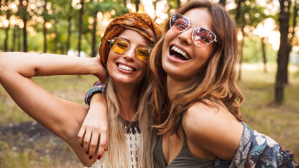 women hippies hugging outside