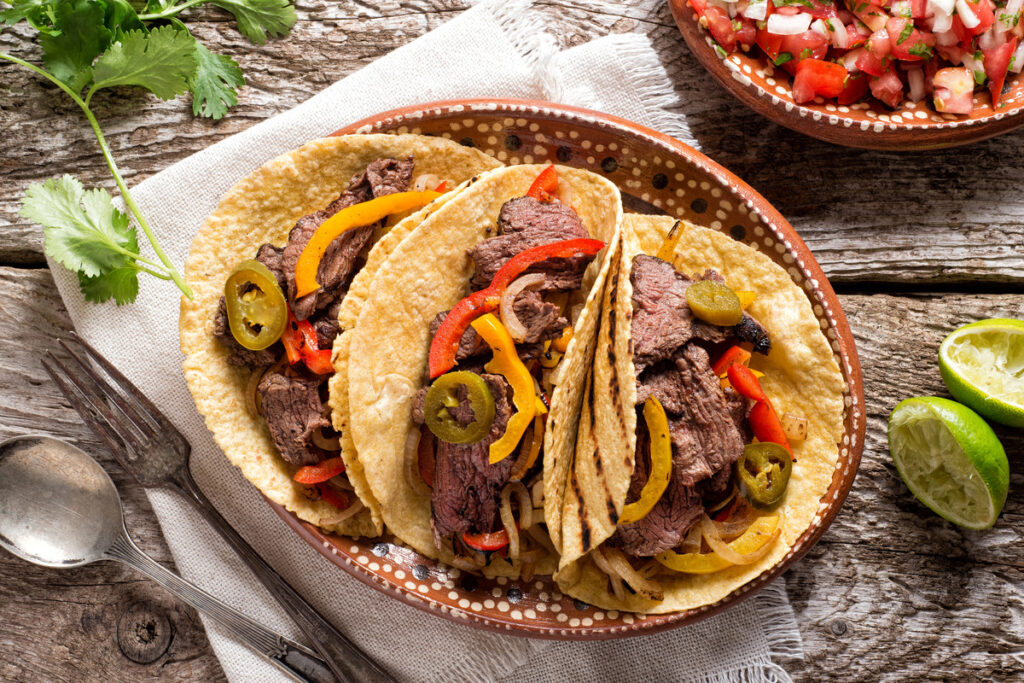 Delicious grilled beef fajitas with steak, onion, bell peppers.