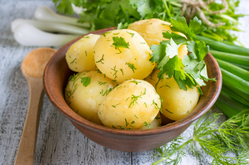 Young boiled potatoes with dill, parsley and onions