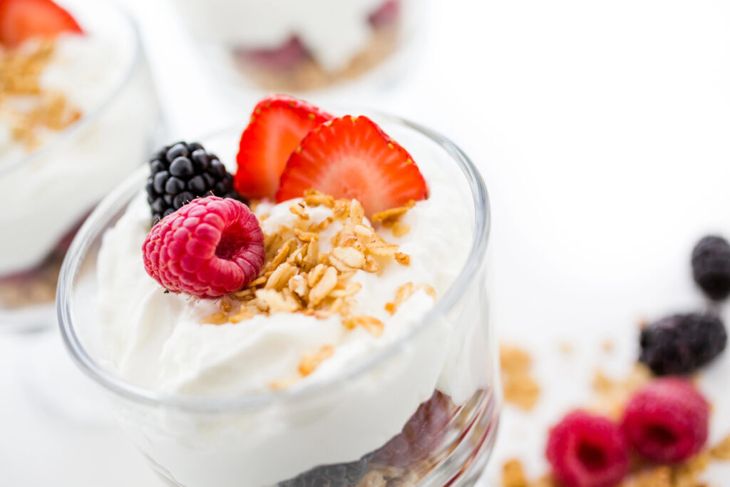 Breakfast parfait made from Greek yogurt and granola topped with fresh berries.