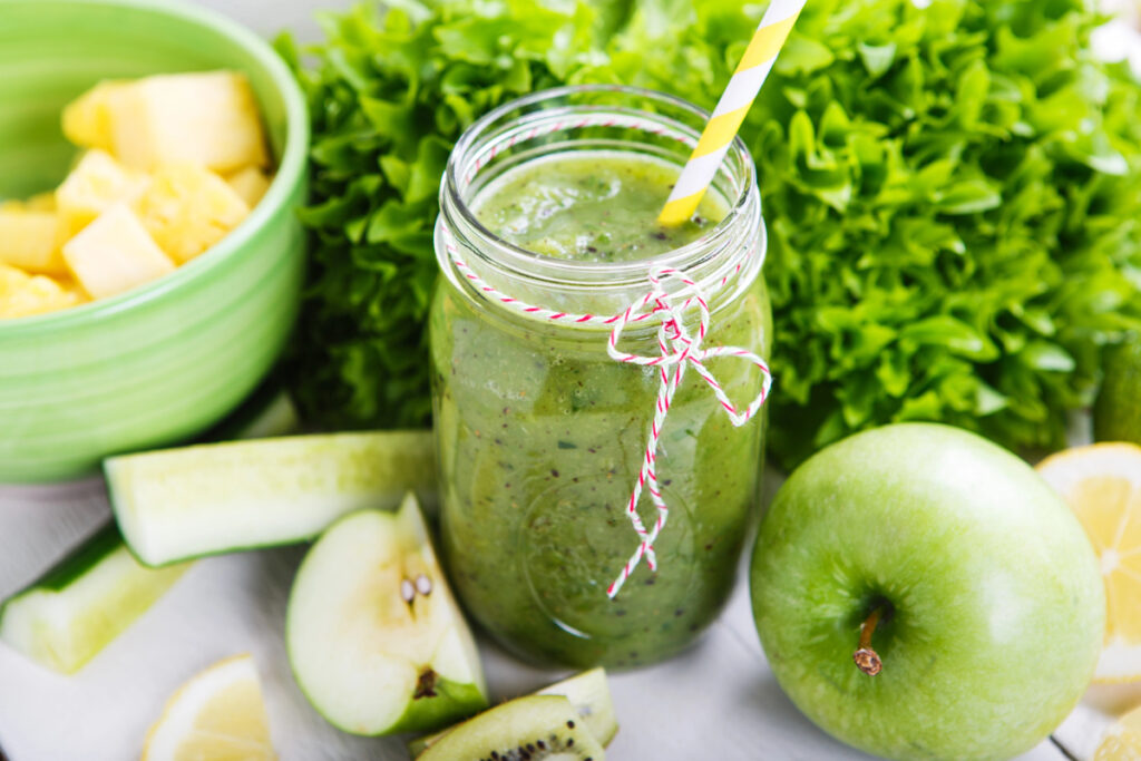 Fresh organic green smoothie with salad, apple, cucumber