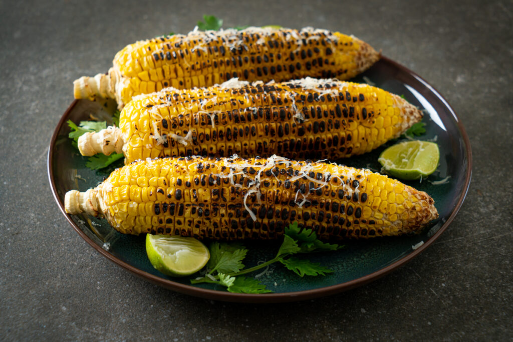 grilled corn with cheese and lime on plate