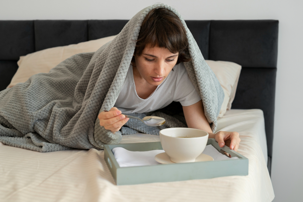 Full shot sick woman with soup