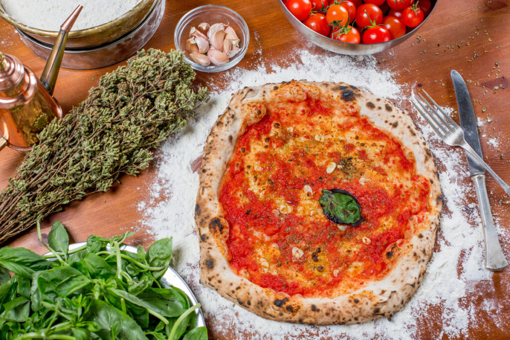 Traditional italian pizza with tomato sauce, garlic and basil