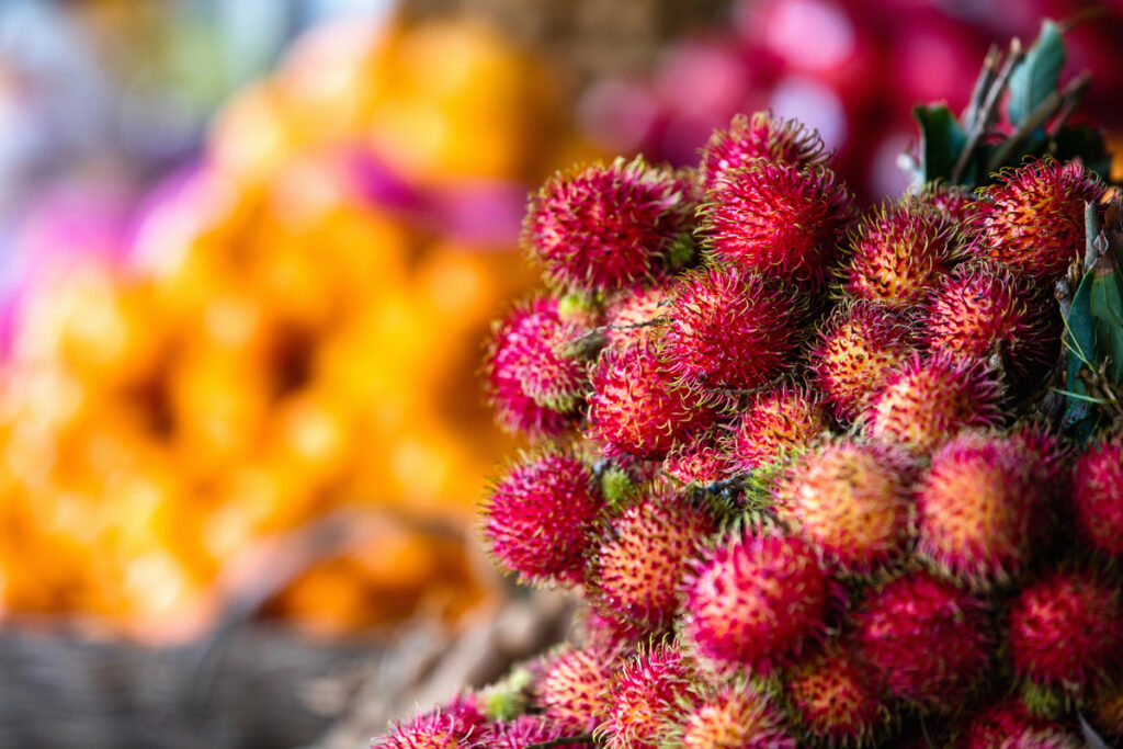 Assortment of fresh exotic rambutan fruits on market stall