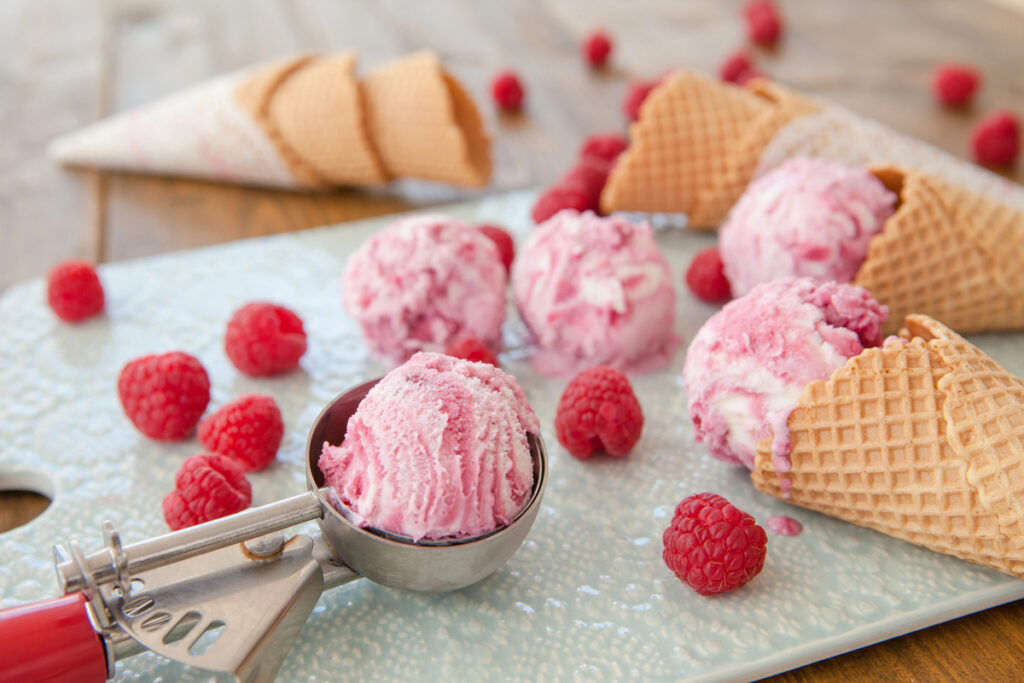 Scoops of raspberry ice cream and waffle cones