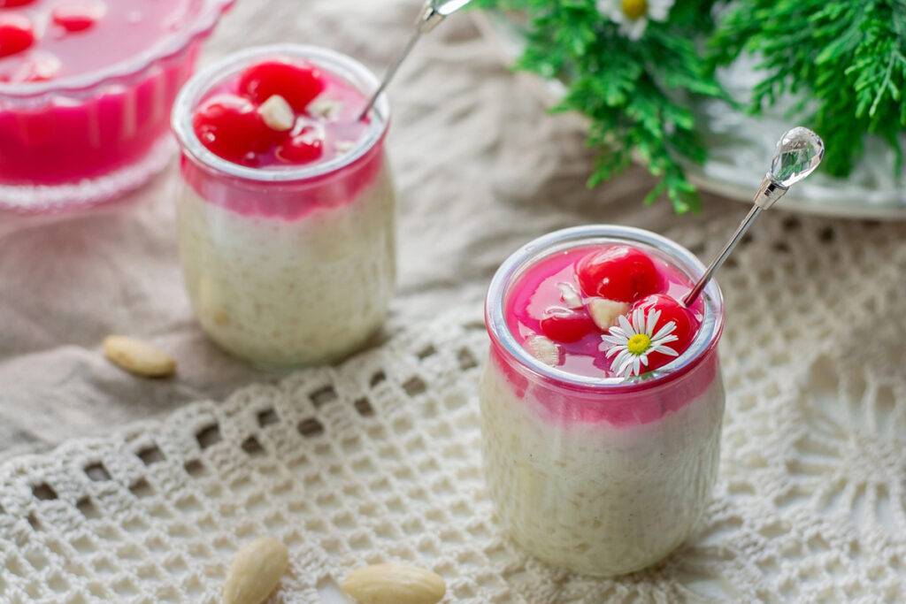 Rice pudding with almonds, whipped cream and cherry sauce