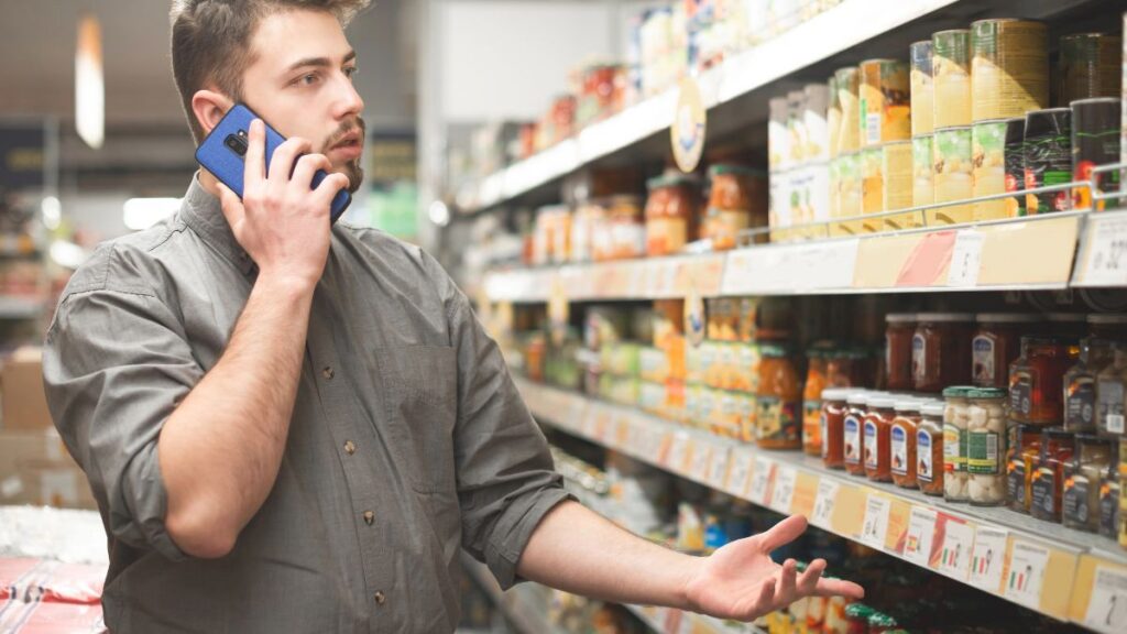 annoyed man in grocery store on phone