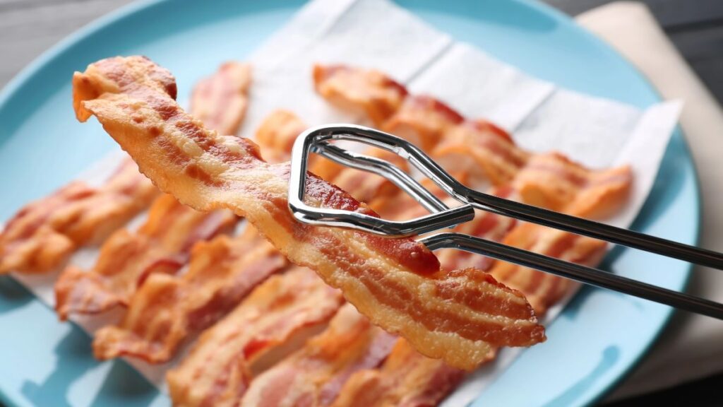 bacon with tongs