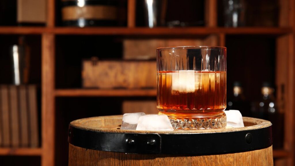 bourbon with ice on barrel