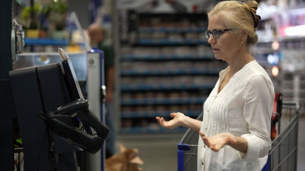 confused woman at self checkout