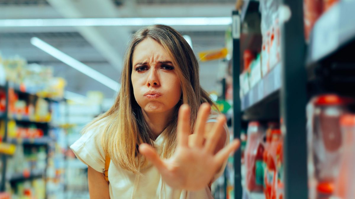 frustrated woman showing stop in grocery store