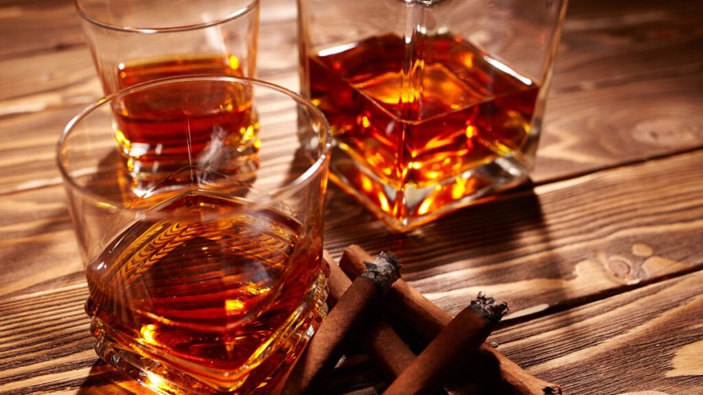 glasses of bourbon with cigars