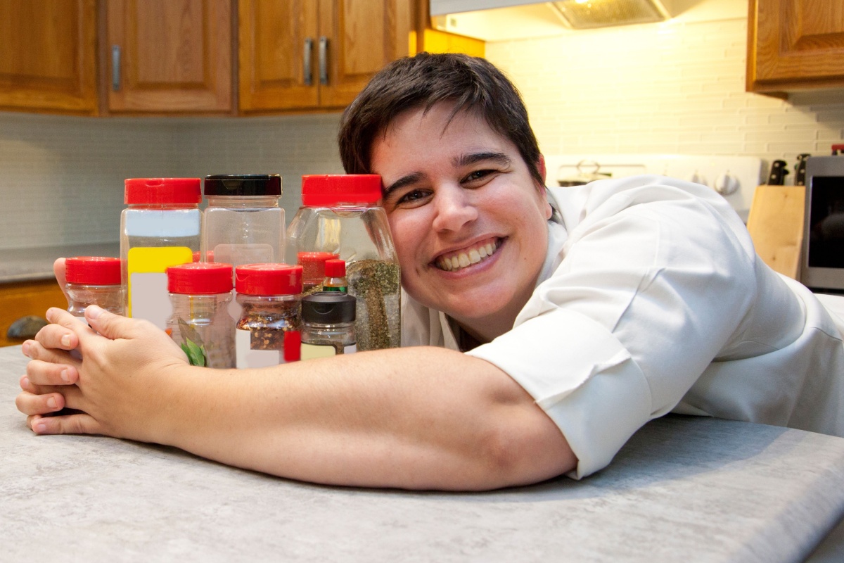 happy chef cook with spices in kitchen