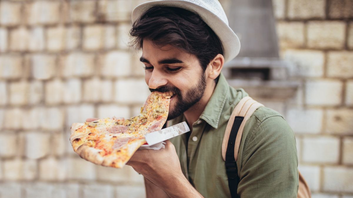 happy man eating pizza