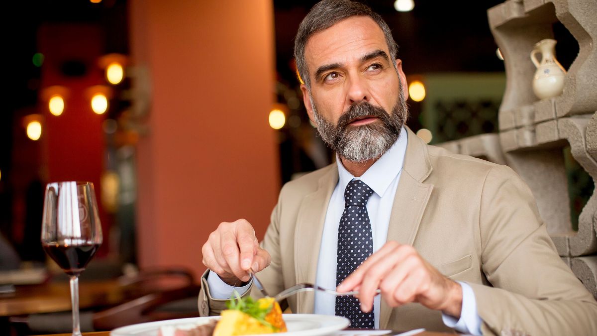 man eating out looking away