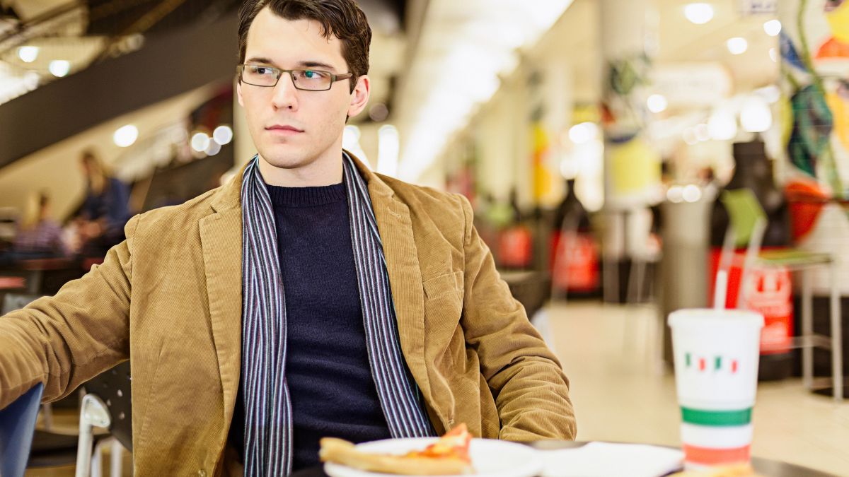 man looking disappointed with food