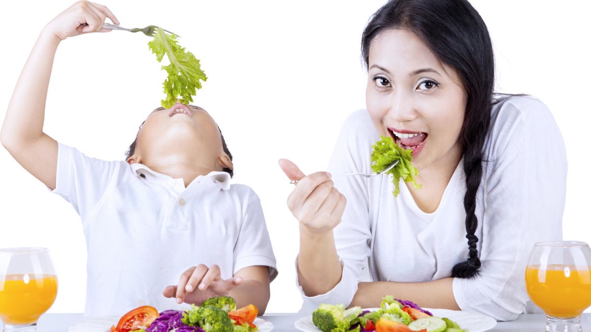 mom and son eating vegetables