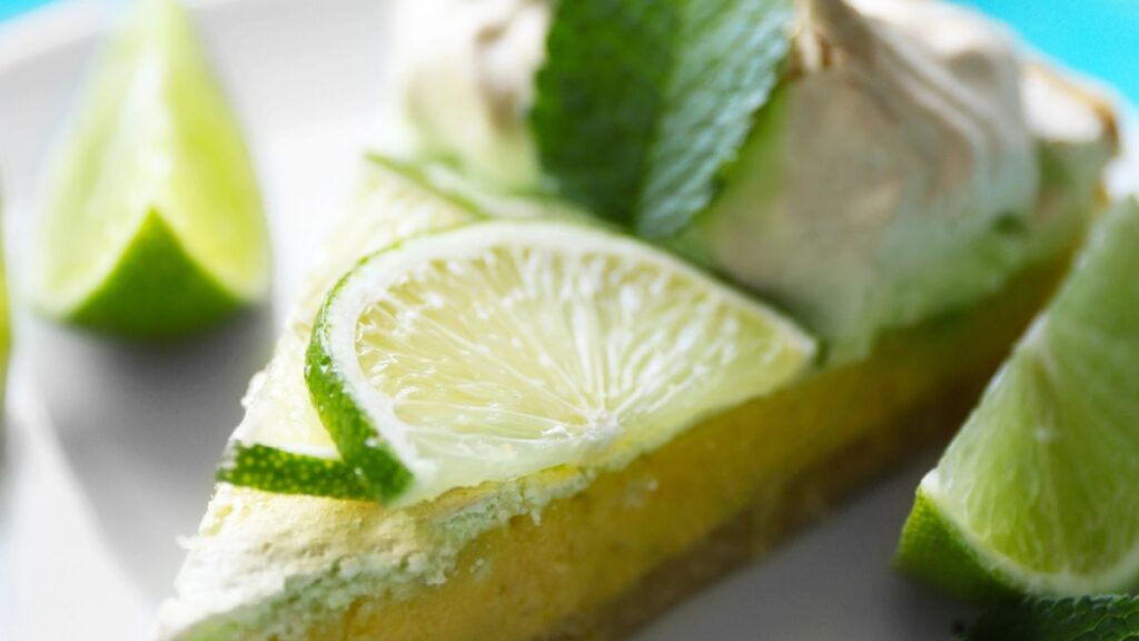 slice of key lime pie with cream and lime