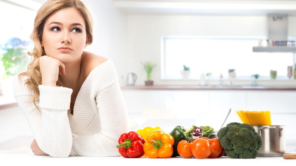 woman frustrated in kitchen with vegetables