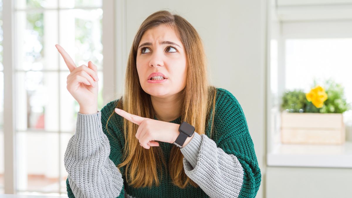 woman looking confused pointing to the side