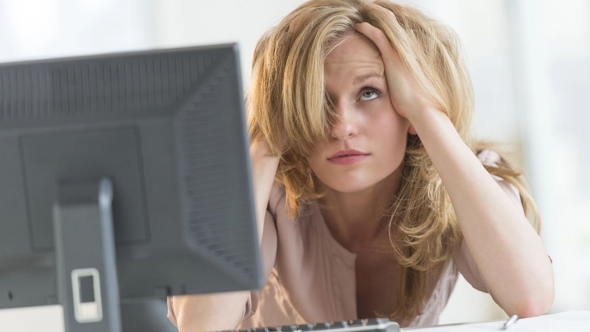 woman looking frustrated at computer