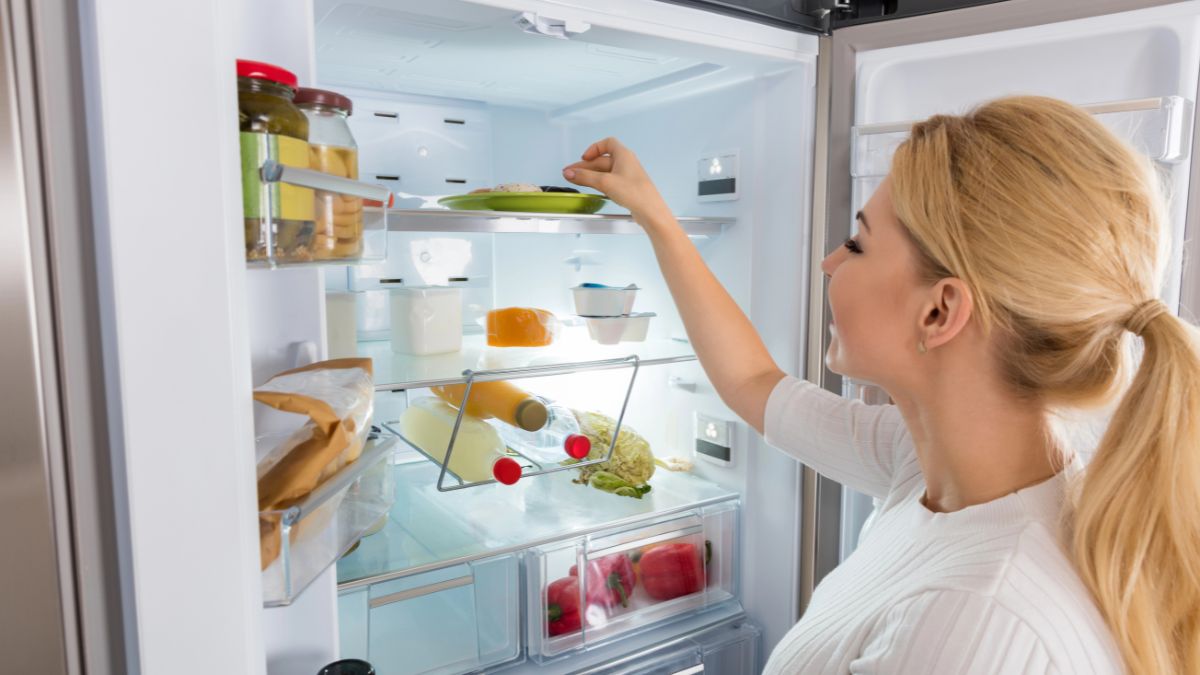 woman looking in fridge