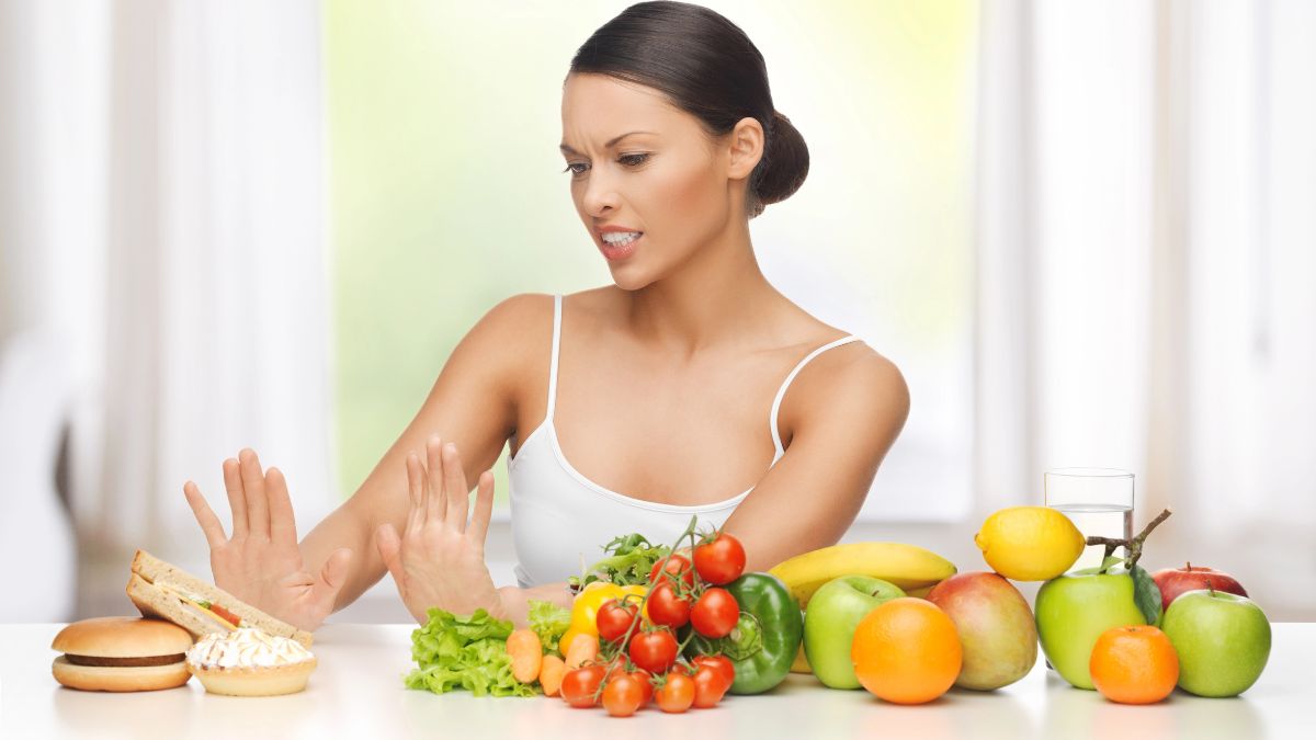 woman pushing junk food away