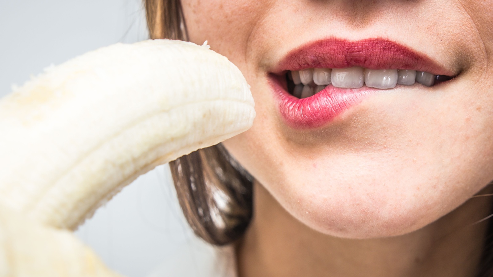 woman resisting eating banana