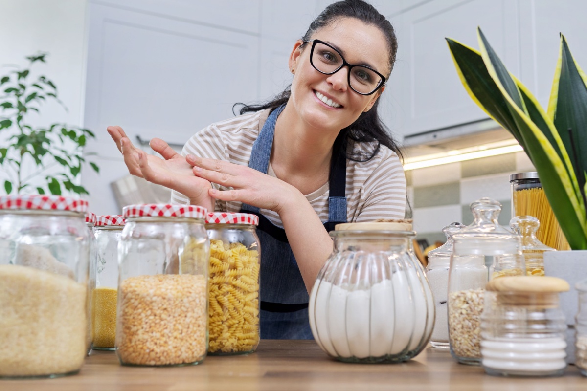 woman showing food storage in jars