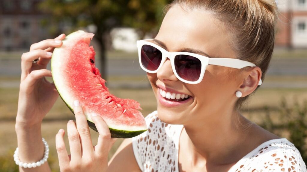 woman smiling eating watermelon