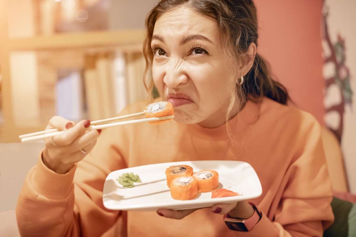 woman sniffing spoiled sushi