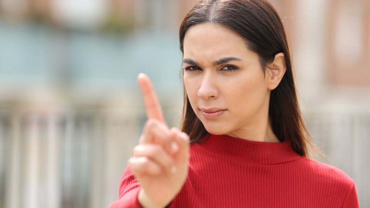 woman with finger up showing no