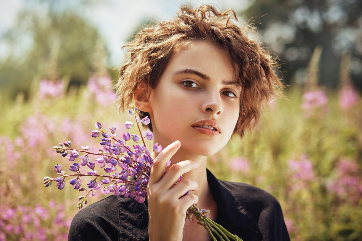 young woman holding lavender herb