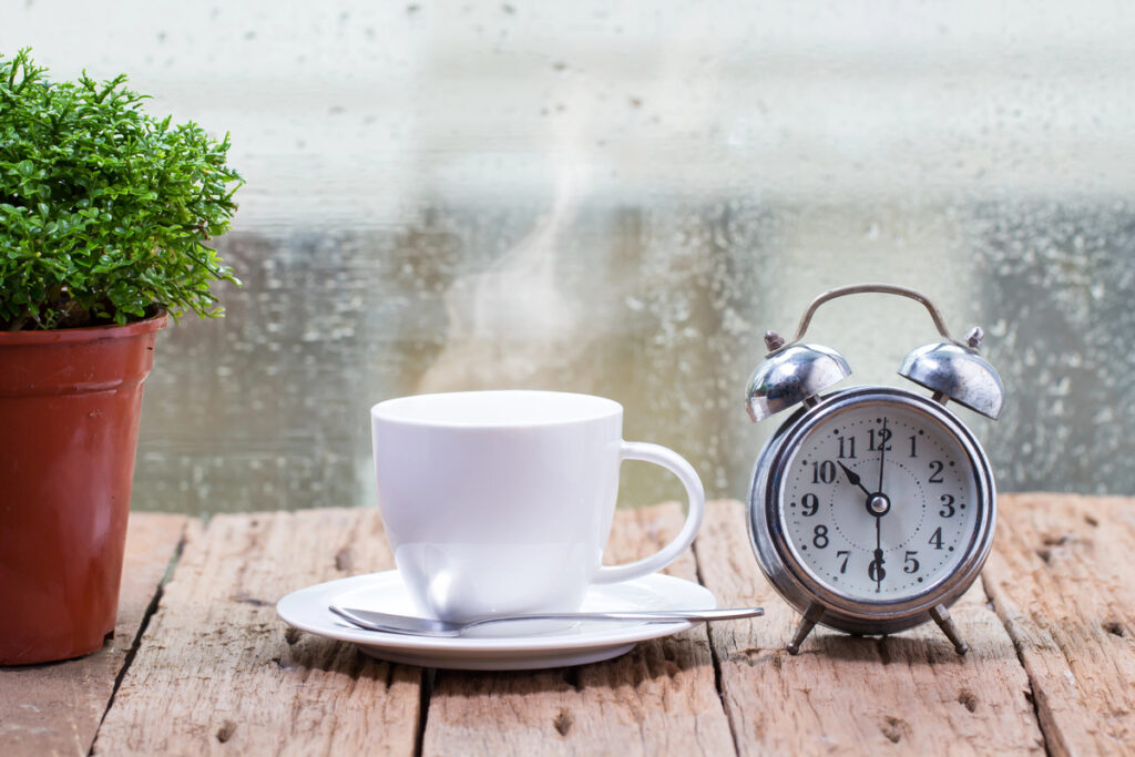 Steaming coffee cup on a rainy day window background,good time of coffee