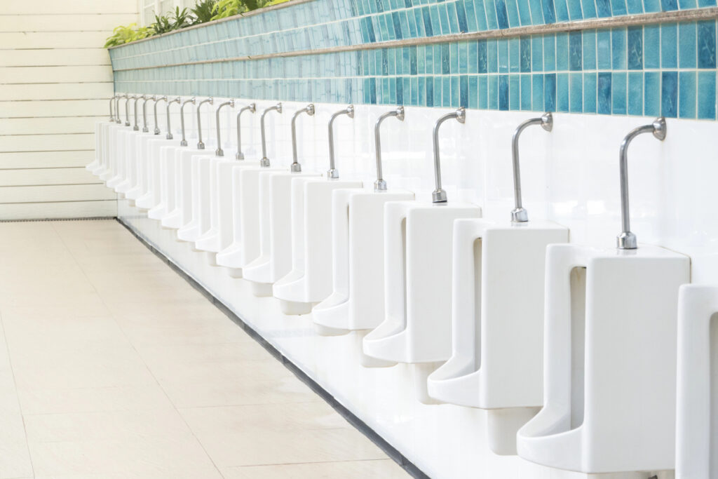 Row urinals in public toilet.