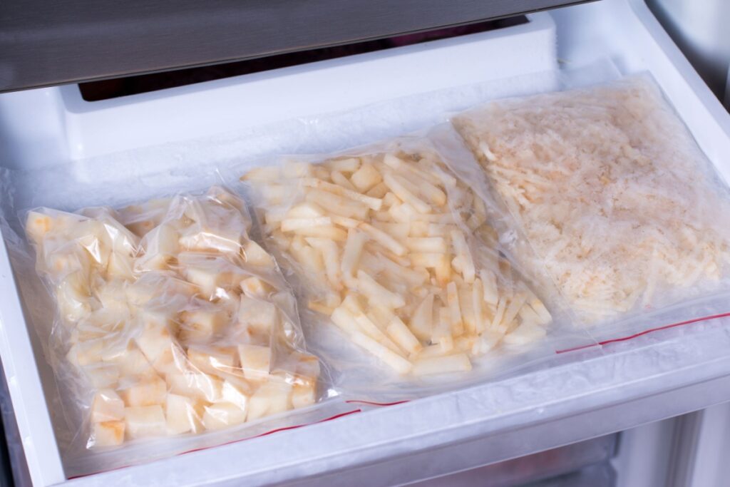 Frozen potatoes in bags in the freezer in the kitchen