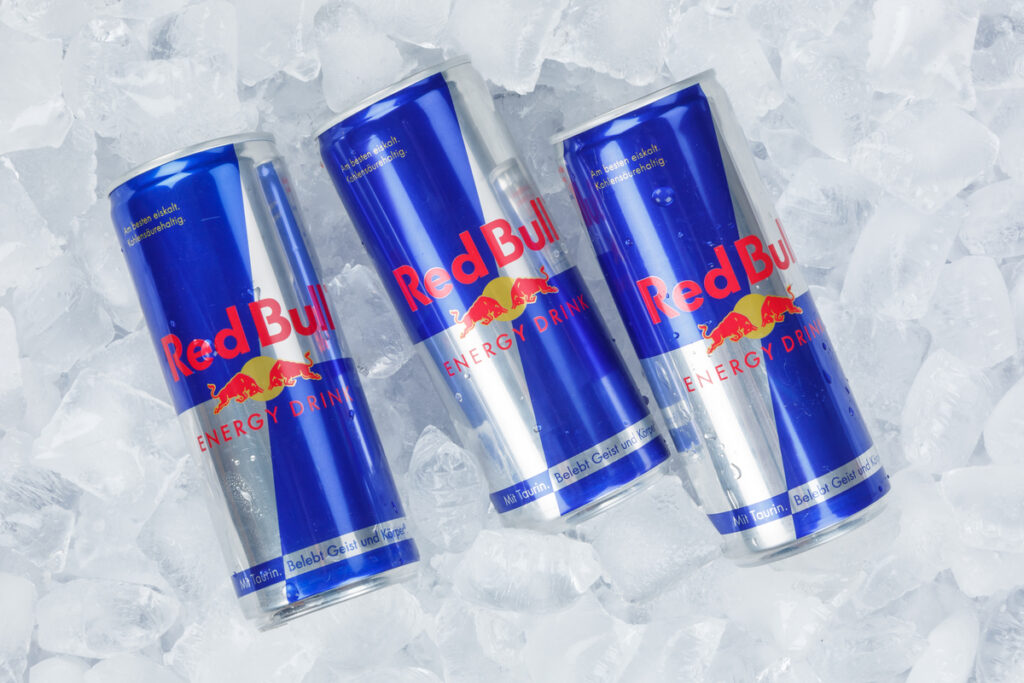 Red Bull Energy Drink lemonade soft drinks in cans on ice cubes